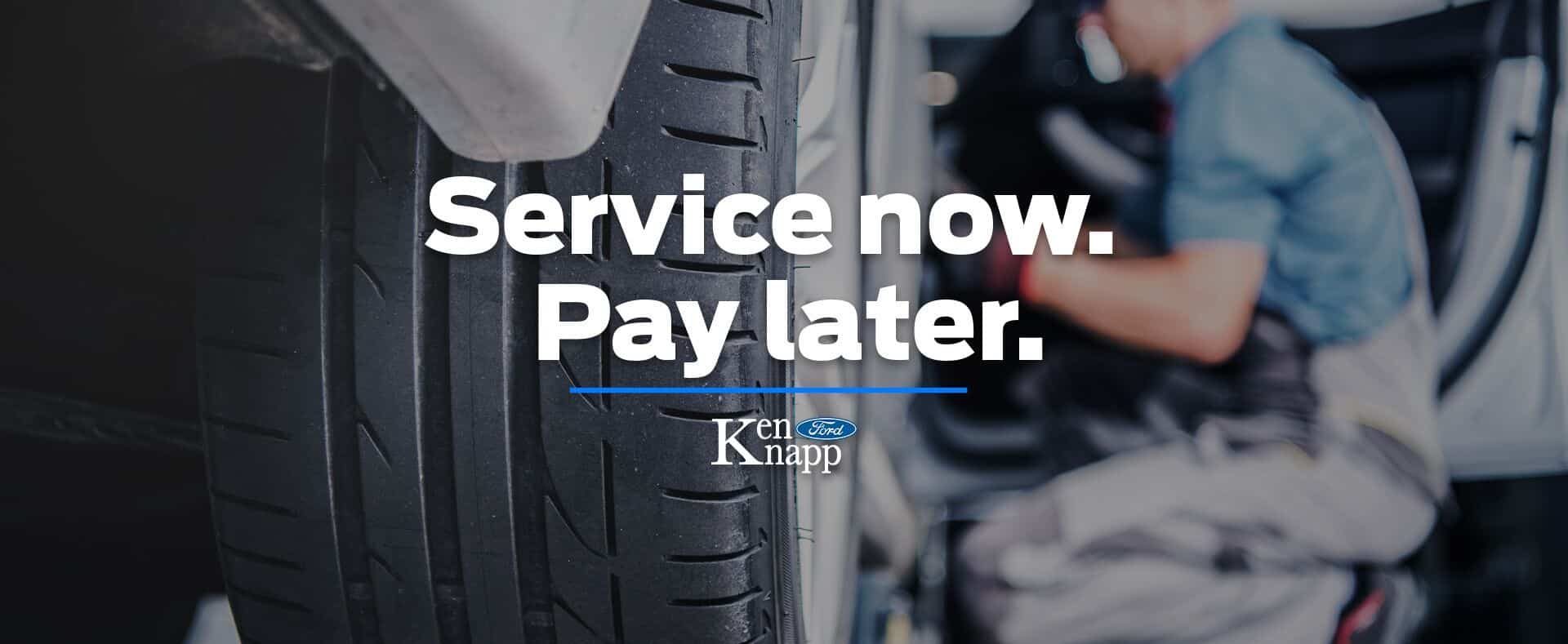 Close-up of a car tire with text "Service now. Pay later." and Ken Knapp Ford logo.